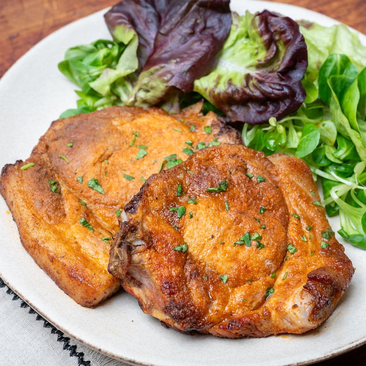 close up photo of an air fryer bone in pork chops
