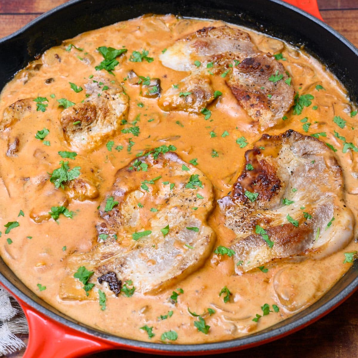 a pan with pieces of pork in a sauce